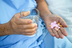 woman taking medication at nursing home